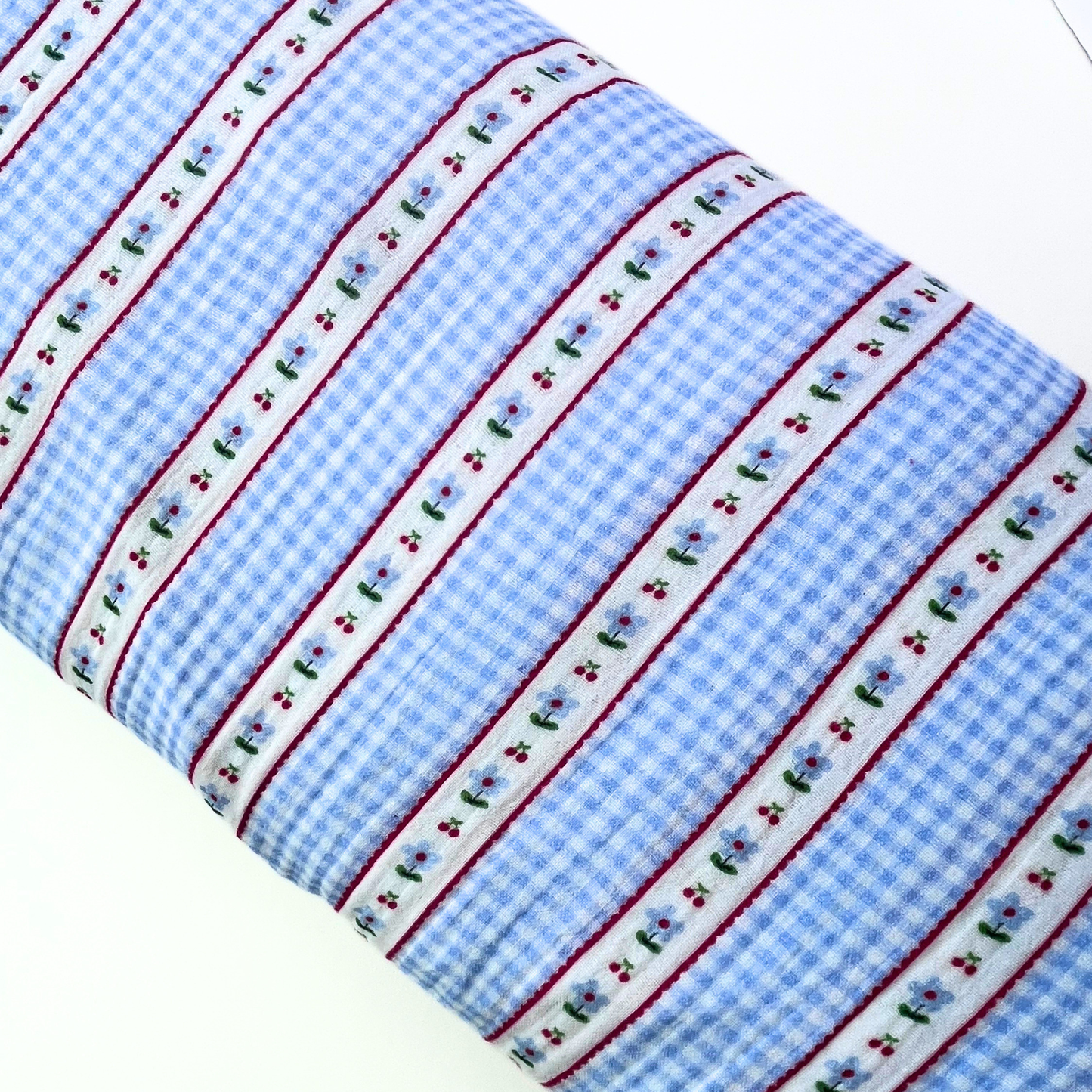 Poppy Fabrics double gauze in light blue and white gingham check with vertical stripe detail folded to show soft two-layer cotton construction — featherlight breathable fabric ideal for handmade baby muslins, children's dresses and relaxed adult blouses