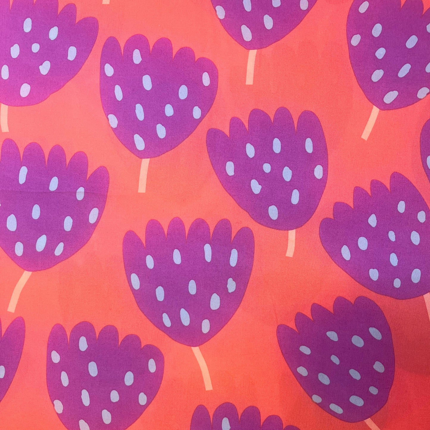 Lightweight cotton poplin fabric in vibrant tulip print, ideal for dressmaking and summer sewing projects.