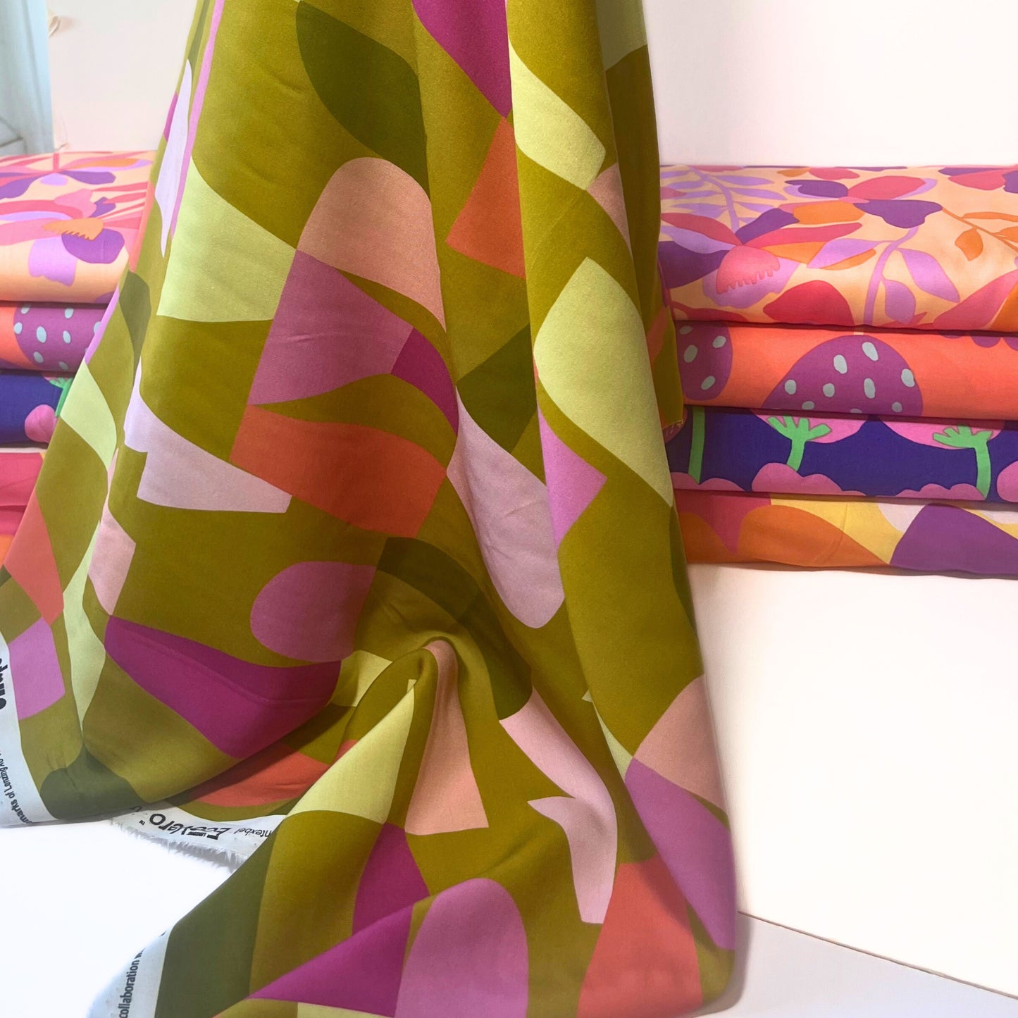 Flat lay of sustainable viscose fabric in Nerida Hansen’s Shape Shifter design, featuring clean, graphic blocks on eco-friendly ECOVERO™ base.