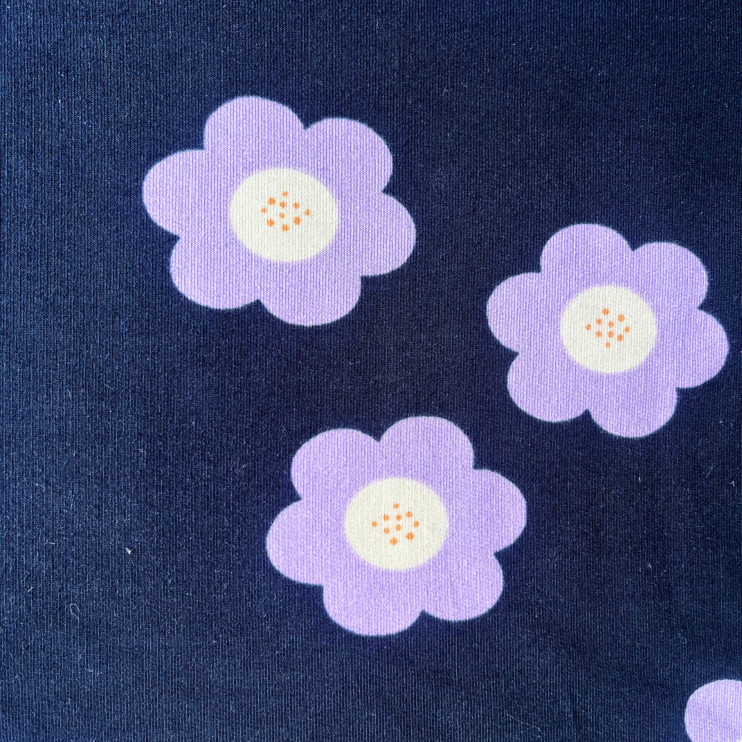 Big Flowers French Terry fabric in navy with bold lilac retro floral print, 150cm wide — soft cotton elastane sweatshirting ideal for handmade adults and children's garments