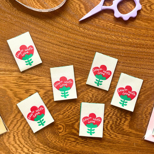 Close-up of a woven "Sewn with Love" sewing label – eco-friendly sewing label detail