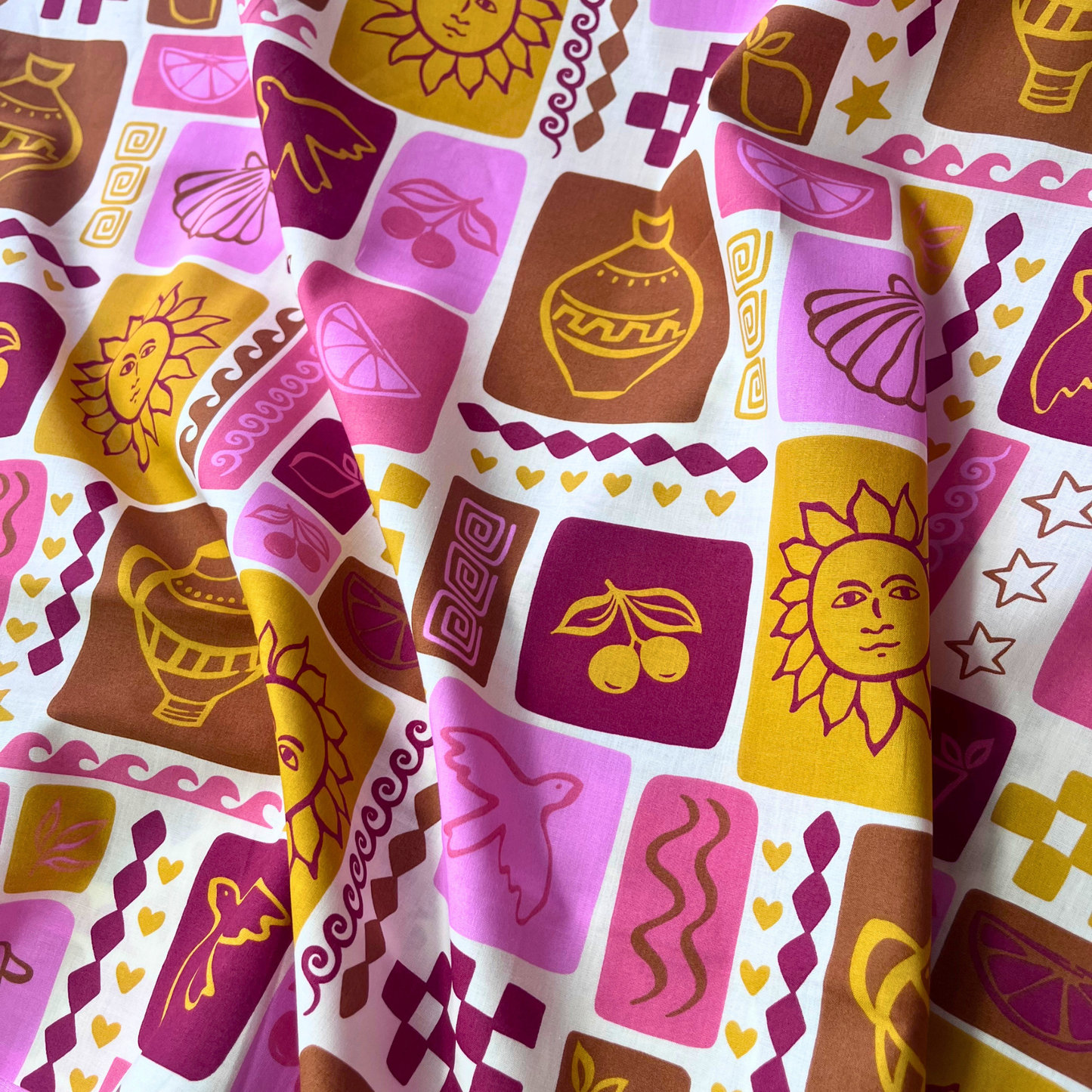 Summer patchwork print cotton poplin fabric on off white base with shells, suns, birds and fruit in pink, ruby red, mustard, ochre and ginger tones, 148cm wide — lightweight 110gsm 100% cotton woven from Poppy Fabrics for handmade summer dresses, blouses and wide-leg trousers