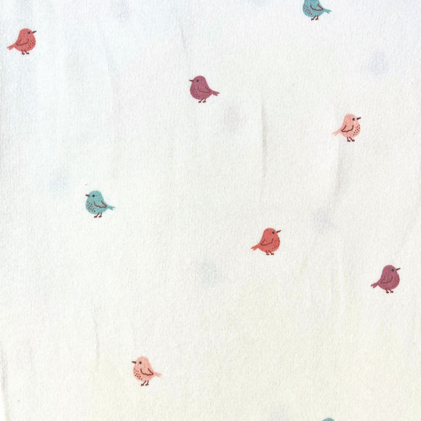 Miniature birds stretch jersey fabric in white with scattered small bird print in soft muted rose, putty and teal, 150cm wide — 200gsm 95% cotton 5% elastane knit for handmade baby and children's clothing