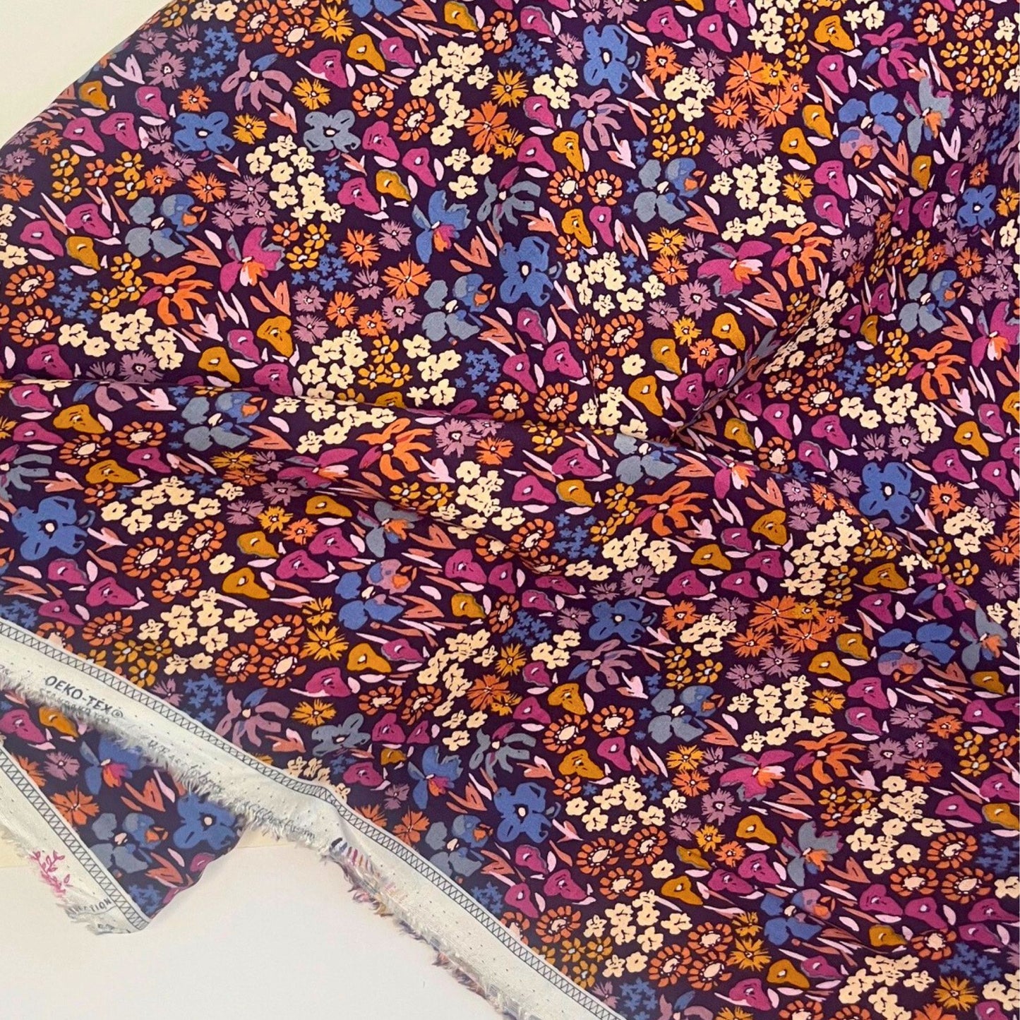 Bloomkind Meadow Dusk premium rayon fabric by Art Gallery Fabrics, featuring a romantic botanical print with meadow florals in dusky pink, plum, orange, and navy on a fluid viscose base