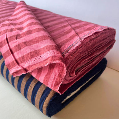 Close-up of washed pink and red yarn dyed stripe cotton fabric showing soft laundered colour and crisp 1.25cm stripe definition — Oeko-Tex Standard 100 certified, ideal for slow fashion dressmaking