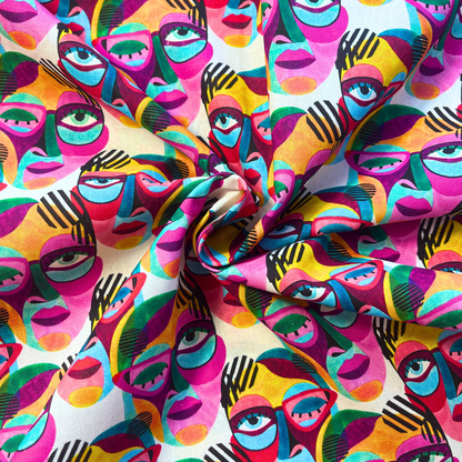 Bold large scale abstract painted faces in rainbow brights on white cotton fabric with graphic black linework — Oeko-Tex Standard 100 certified 100% cotton woven from Little Johnny for statement slow fashion dressmaking and quilting