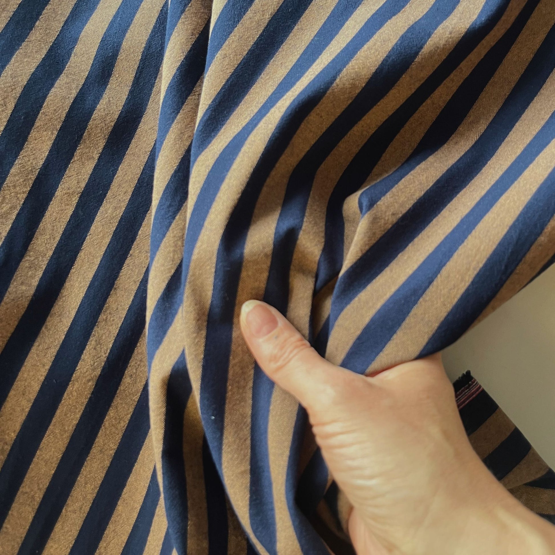 Close-up of navy and brown yarn dyed stripe cotton fabric showing crisp 1.25cm stripe definition and soft woven texture — Oeko-Tex Standard 100 certified, ideal for slow fashion dressmaking
