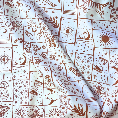 Celestial patchwork print cotton poplin fabric on white base with irregular caramel and ginger patches filled with tigers, florals, stars and moons, 148cm wide — lightweight 110gsm 100% cotton woven for handmade statement blouses, dresses and wide-leg trousers