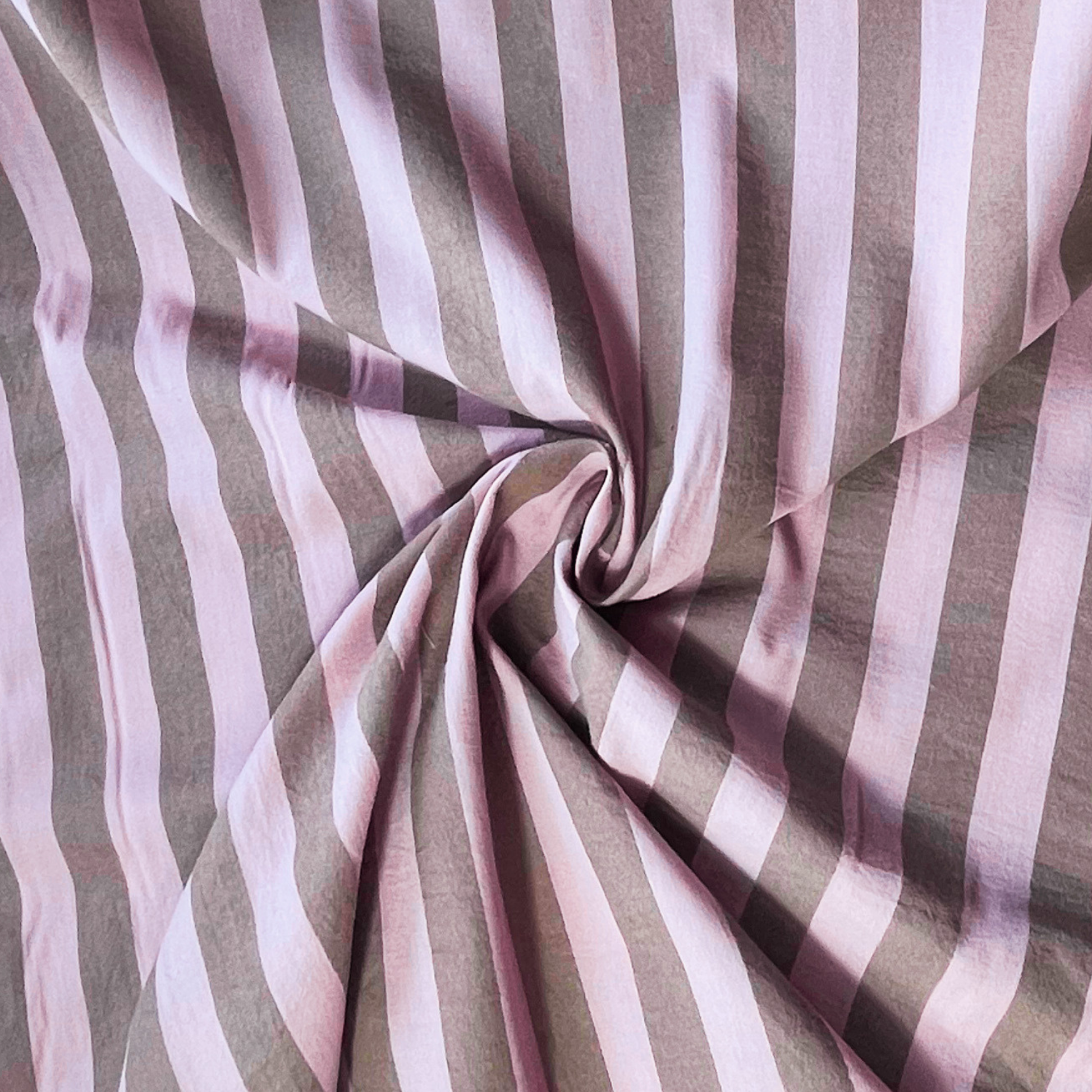 Pale pink brown 3cm yarn dyed stripe cotton fabric draped to show natural drape and 145cm width — coordinates with matching gingham for handmade children's pinafores summer dresses and blouses