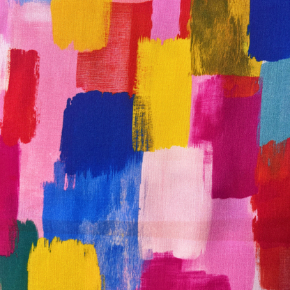 A close-up of a colorful abstract painted pattern with broad brushstrokes in pink, yellow, blue, red, green, and light blue on a fabric-like surface.