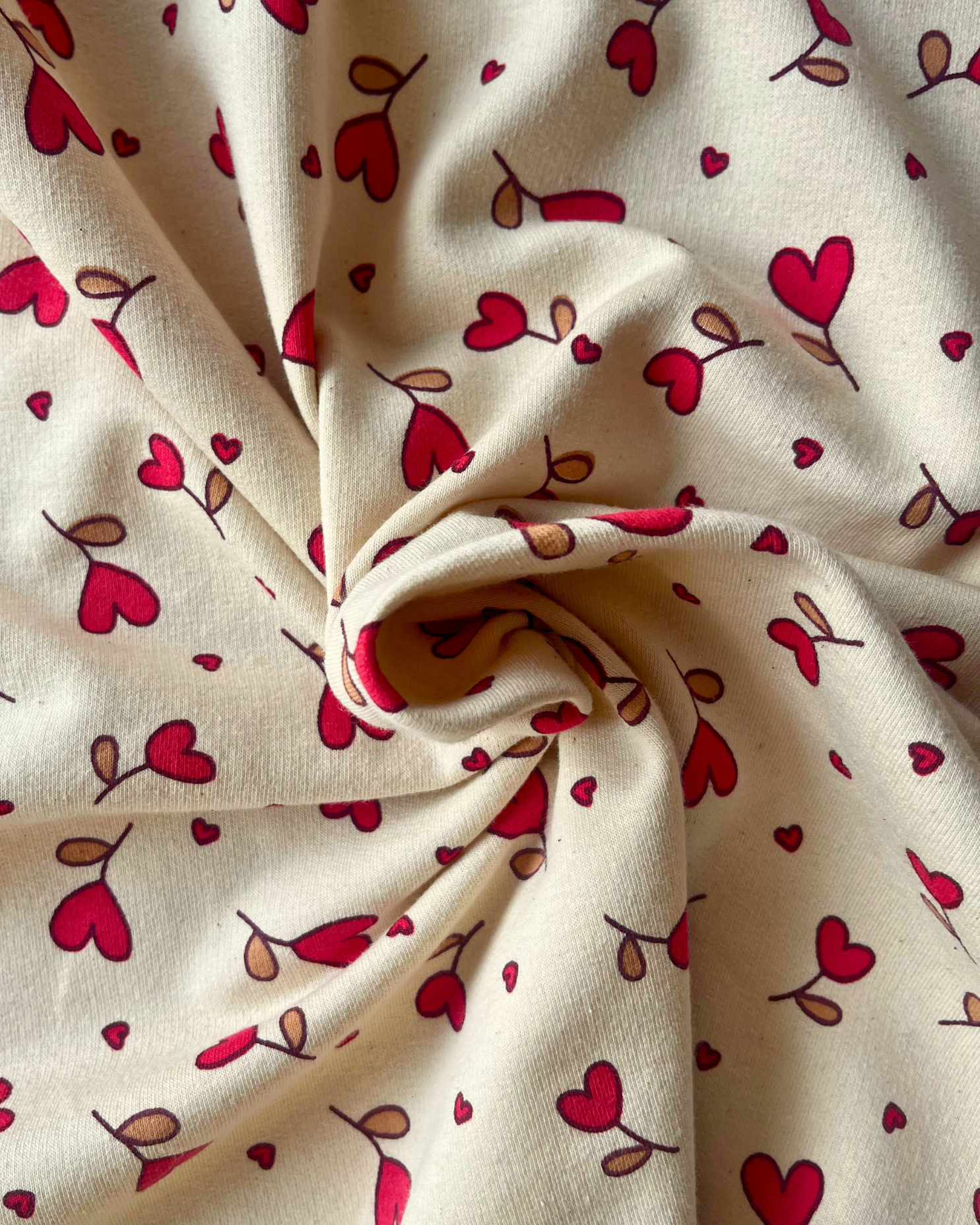 Supersoft brushed back sweatshirting in natural with small red hearts — Oeko-Tex Class 1 certified fabric for handmade baby gifts and children's loungewear