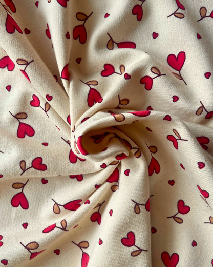 Supersoft brushed back sweatshirting in natural with small red hearts — Oeko-Tex Class 1 certified fabric for handmade baby gifts and children's loungewear