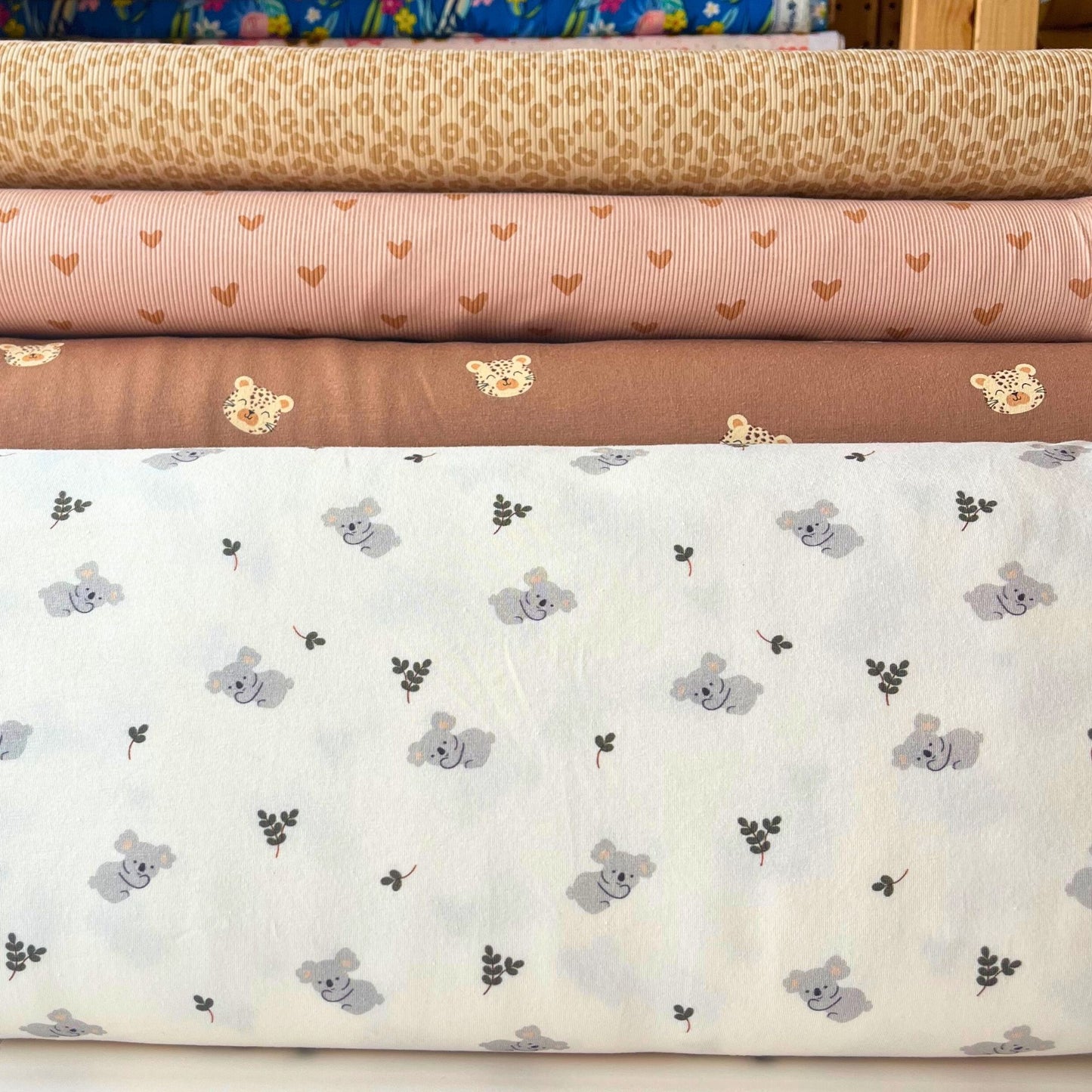 Koala jersey fabric laid flat, ideal for rompers and sleepsuits.