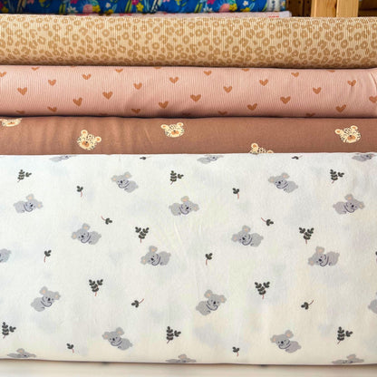 Koala jersey fabric laid flat, ideal for rompers and sleepsuits.
