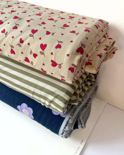 Supersoft brushed back sweatshirting in natural with small red hearts — Oeko-Tex Class 1 certified fabric for handmade baby gifts and children's loungewear