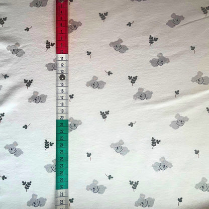 Koala jersey fabric laid flat, ideal for rompers and sleepsuits. Perfect for newborns