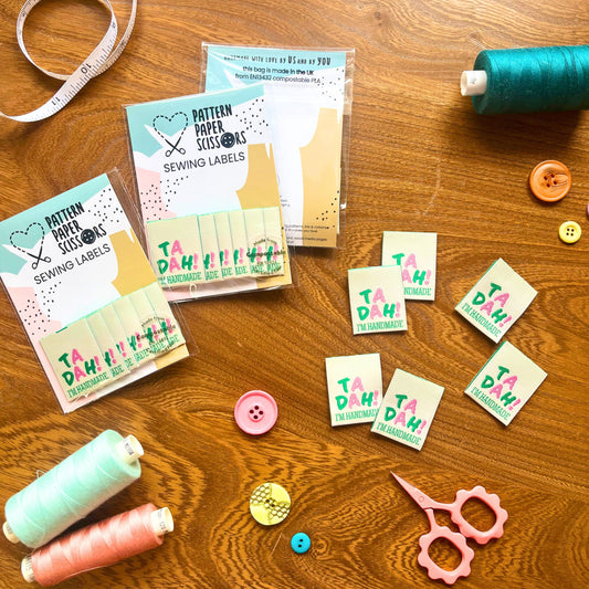 Eco-friendly folded sew-in label for dressmaking, reading “Ta-Dah! I’m Handmade,” made from recycled polyester.