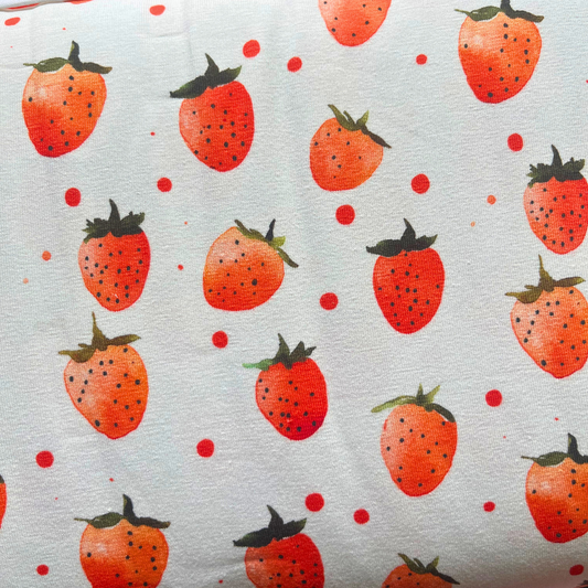 Strawberries digital print stretch jersey fabric in cream with scattered red strawberry print, 150cm wide — soft 95% cotton 5% elastane knit ideal for handmade children's clothing and adult dressmaking