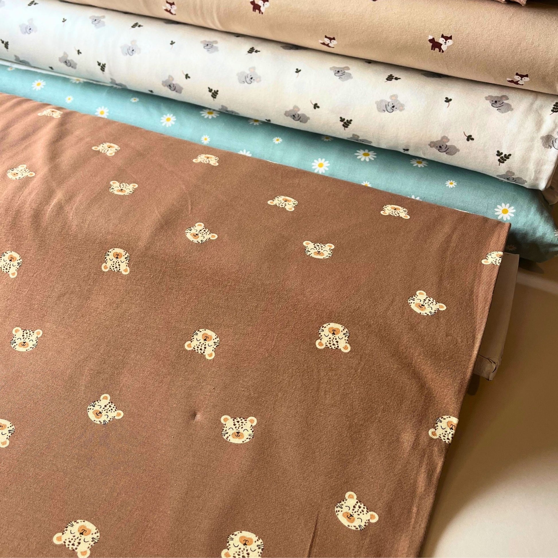 Warm brown animal print cotton jersey for handmade toddler outfits.