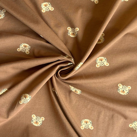 Eco-conscious kids fabric with leopard head design ready for dressmaking projects.