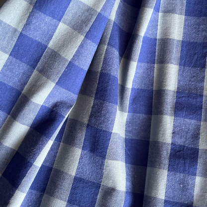 Close-up of blue and teal yarn dyed gingham showing crisp woven check lines and cool contemporary colour combination — Oeko-Tex Standard 100 certified cotton fabric for women's dressmaking