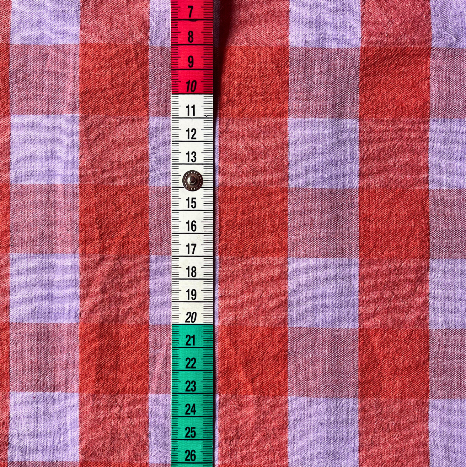 Close-up of burnt orange and lavender yarn dyed gingham showing crisp woven check lines and bold on-trend colour combination — Oeko-Tex Standard 100 certified cotton fabric for women's dressmaking