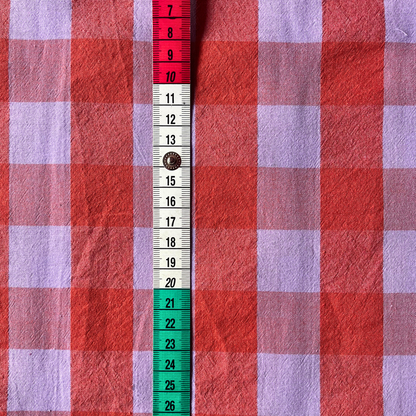 Close-up of burnt orange and lavender yarn dyed gingham showing crisp woven check lines and bold on-trend colour combination — Oeko-Tex Standard 100 certified cotton fabric for women's dressmaking
