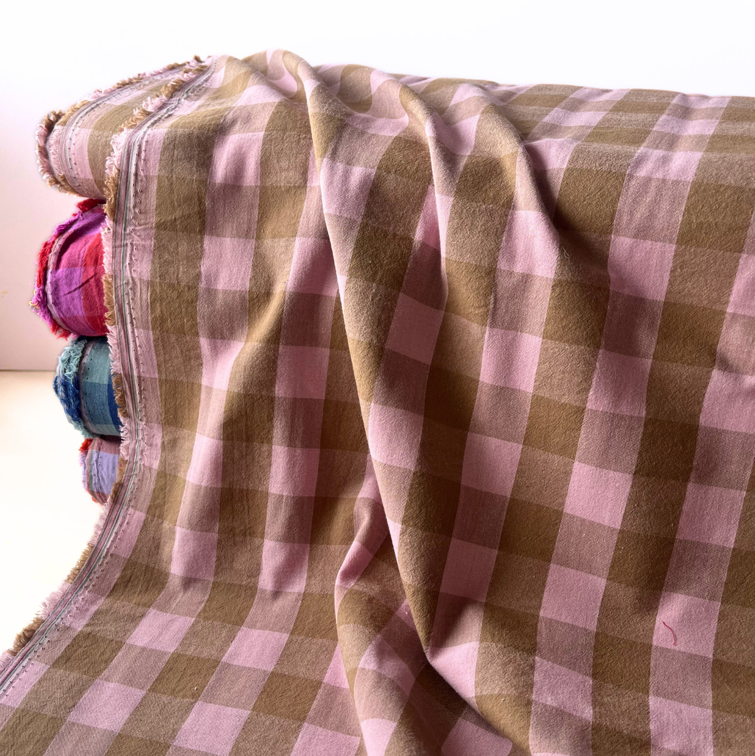 Close-up of pale pink and warm brown yarn dyed gingham check showing crisp colour-woven lines and soft cotton weave — Oeko-Tex Standard 100 certified, ideal for women's dressmaking and slow fashion sewing