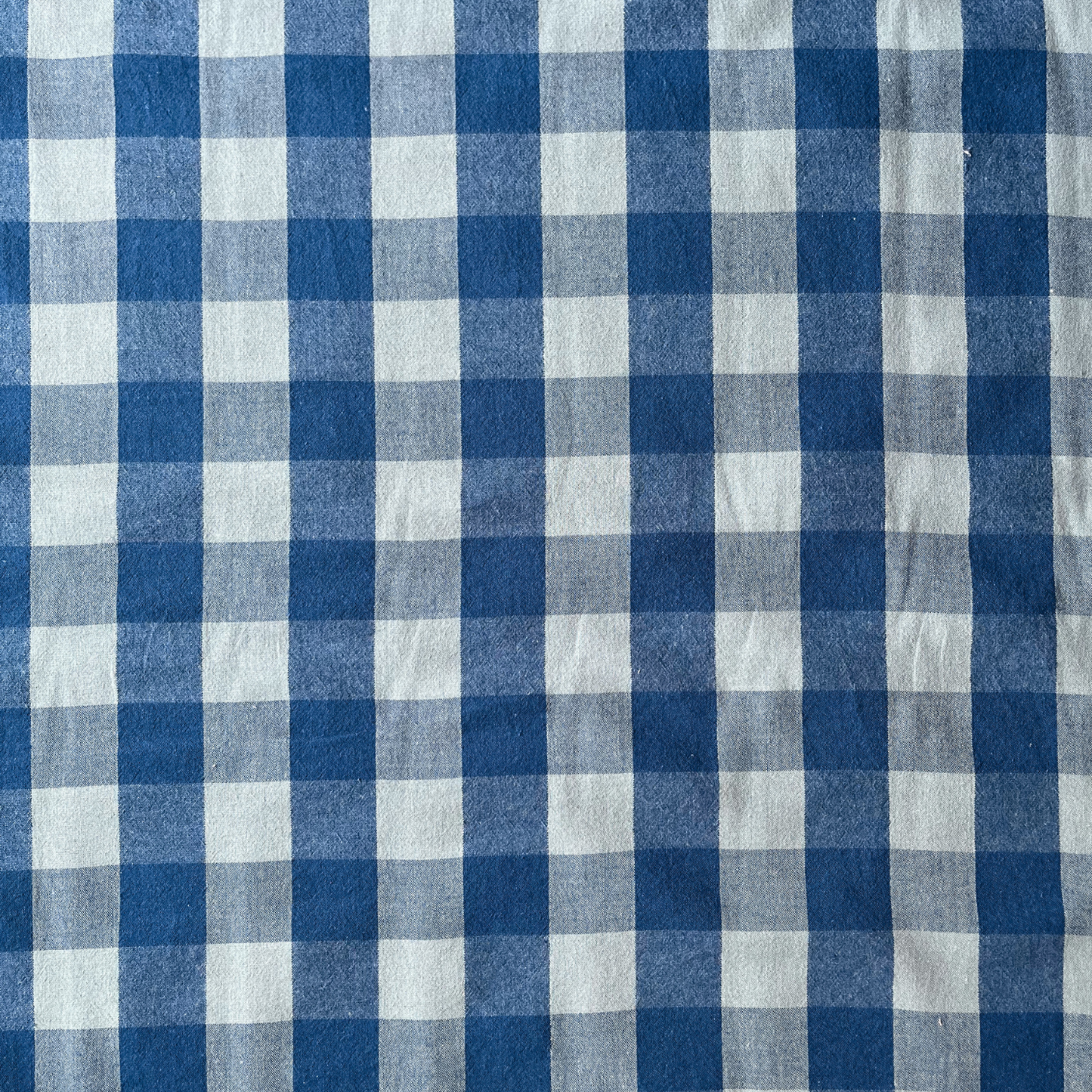 Cool blue and teal gingham woven cotton fabric folded to show yarn dyed check construction — modern 3cm gingham in a fresh palette, ideal for handmade women's blouses and relaxed summer dresses