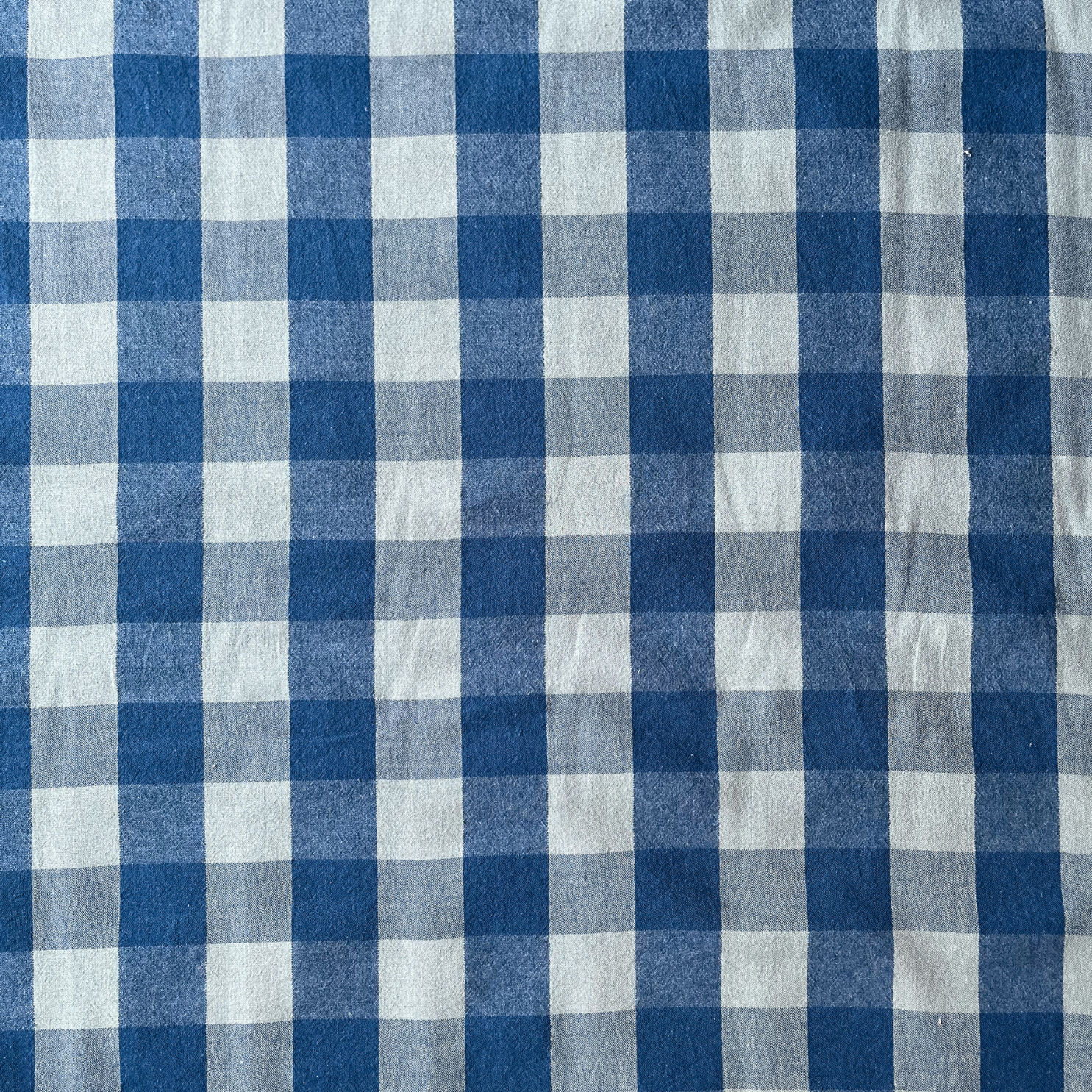 Cool blue and teal gingham woven cotton fabric folded to show yarn dyed check construction — modern 3cm gingham in a fresh palette, ideal for handmade women's blouses and relaxed summer dresses