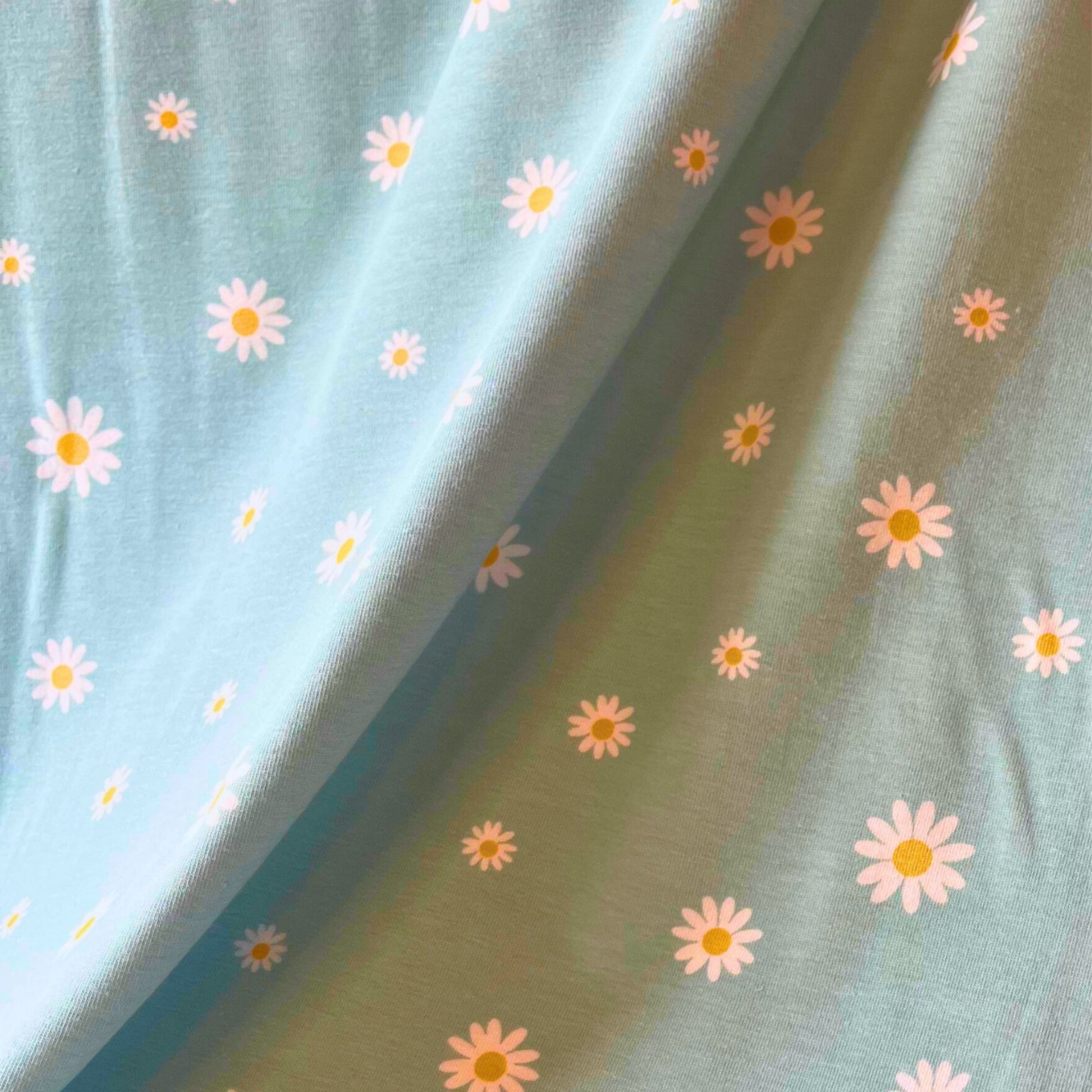 Close-up of soft stretch jersey with white daisy floral print