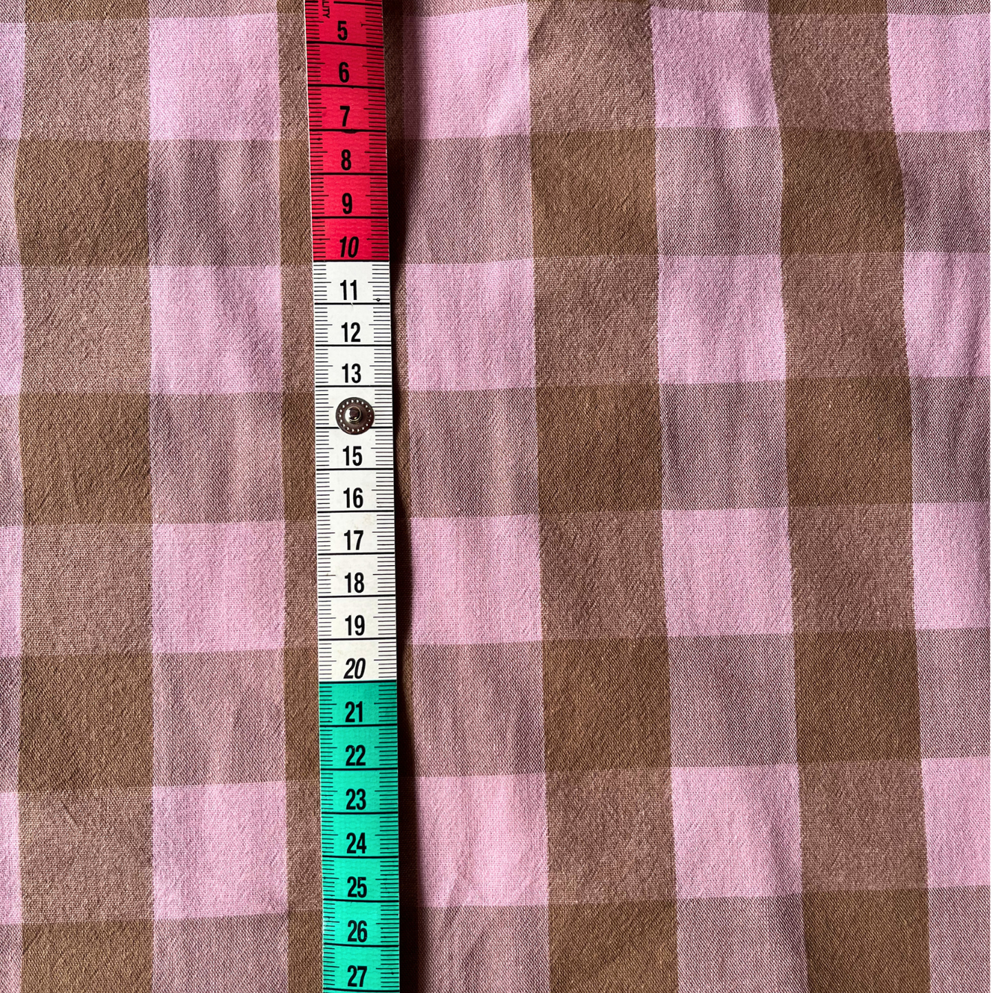 Flat lay of blush pink and brown gingham cotton fabric draped to show 135gsm weight and natural drape — 3cm check woven fabric perfect for handmade women's pinafores, blouses and wrap skirts in a beyond nine style