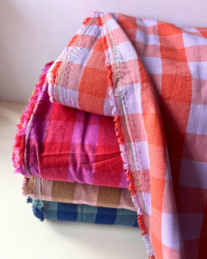 Four colourways of yarn dyed gingham check cotton fabric shown together — pale pink and brown, red and cerise, blue and teal, burnt orange and lavender — 3cm square check, 145cm wide, Oeko-Tex Standard 100 certified woven cotton for women's dressmaking and slow fashion sewing