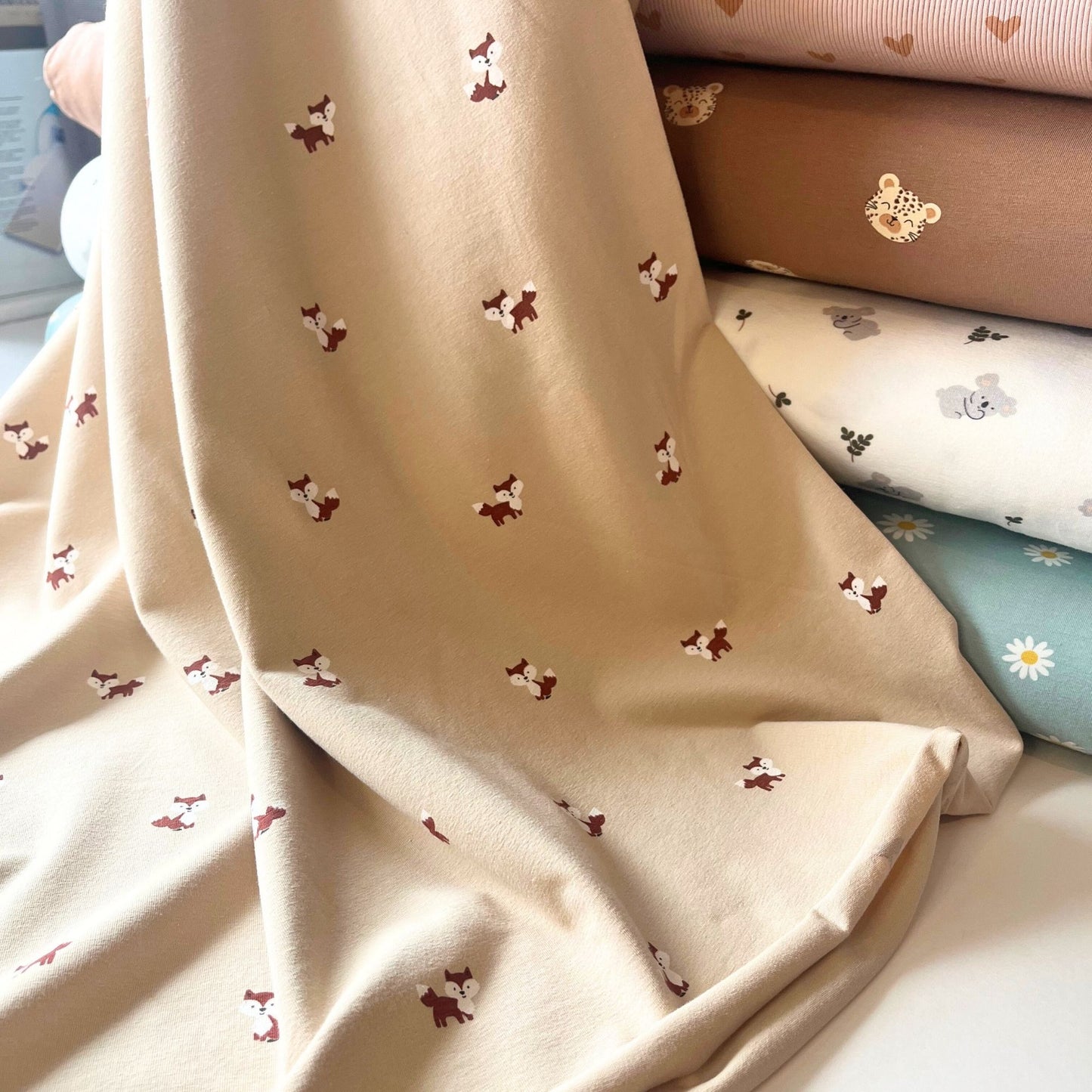 Warm-toned knit fabric ready for sewing baby accessories and cosy play sets.