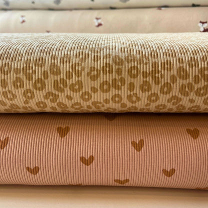 Two rolls of fabric with patterns on a beige background
