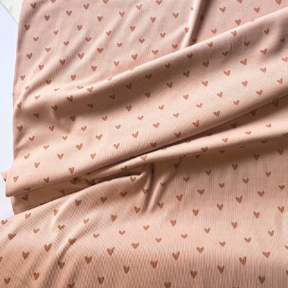 View of nude and muted rose heart rib knit jersey for handmade garments.