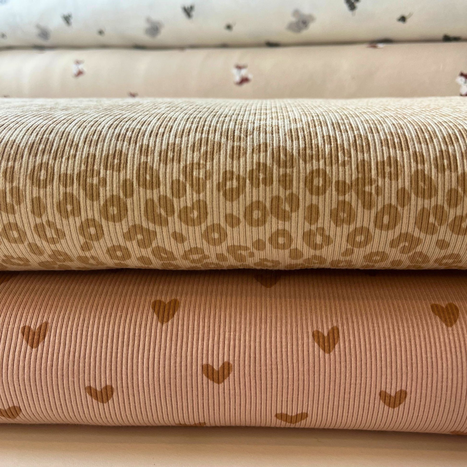 Folded view of leopard print rib knit jersey showing texture and elastic stretch.