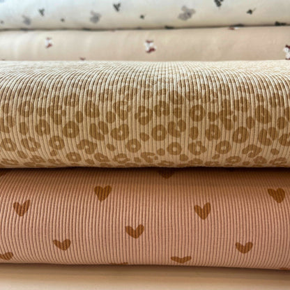 Folded view of leopard print rib knit jersey showing texture and elastic stretch.