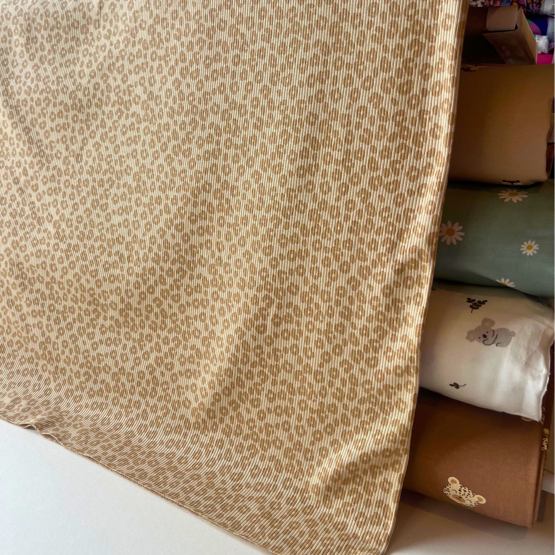 Close-up of leopard print fabric with alternative fabrics in the background