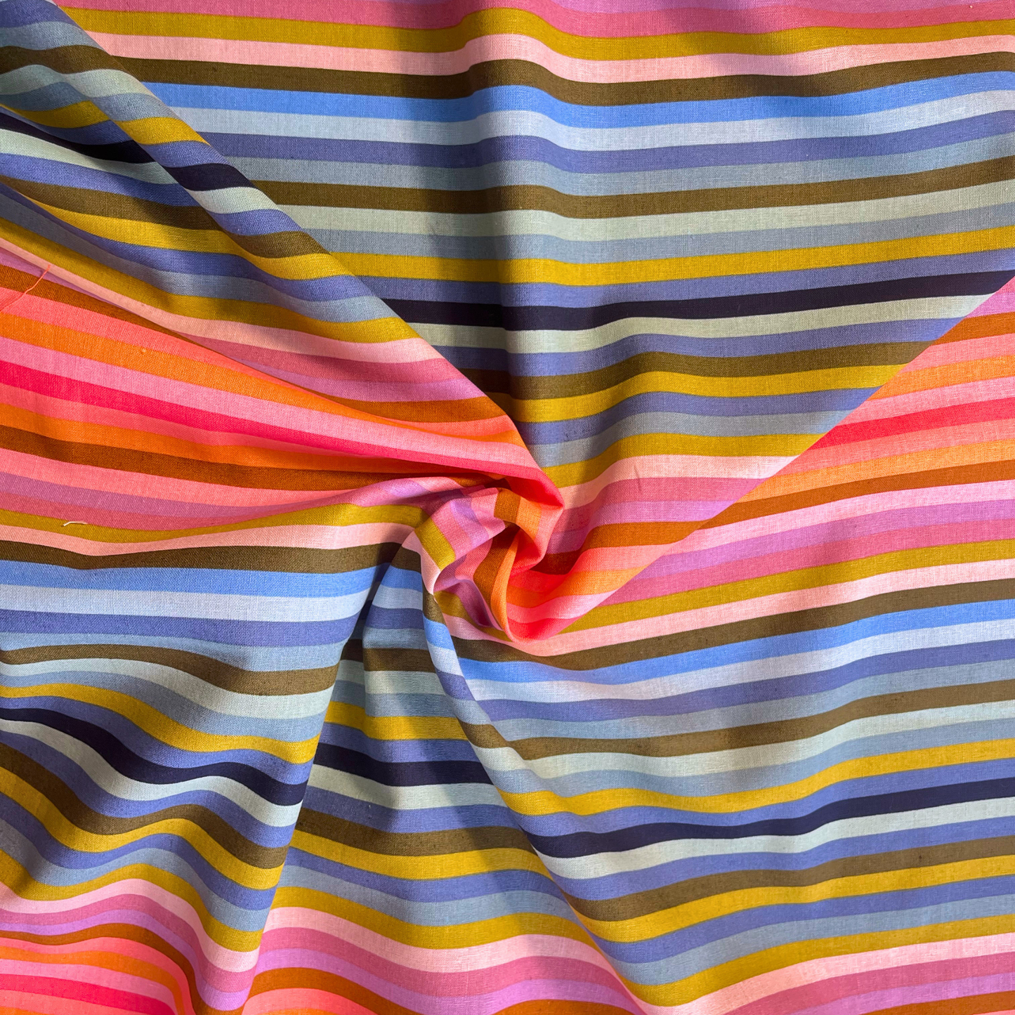 Maureen Cracknell Starling AGF rainbow stripe linen blend fabric folded to show 30cm full spectrum stripe repeat and natural linen texture — 142cm wide Oeko-Tex certified dressmaking fabric for handmade dresses trousers and blouses