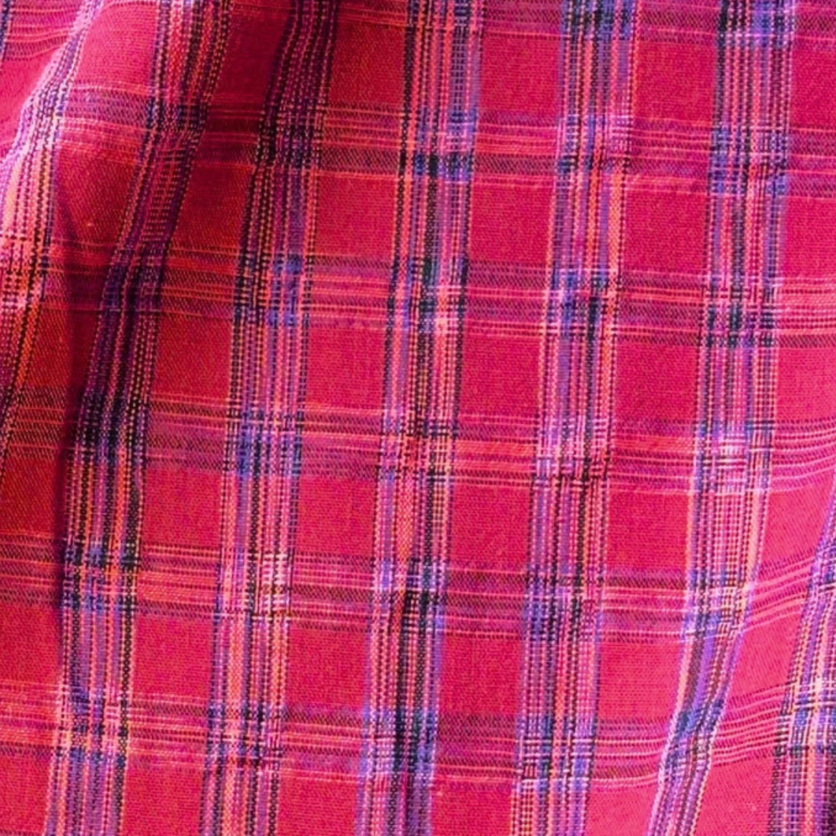 Berry pink cobalt blue neon check cotton fabric flat lay showing 100gsm fluid drape and 142cm width — yarn dyed 2cm check perfect for handmade dresses midi skirts and lightweight blouses