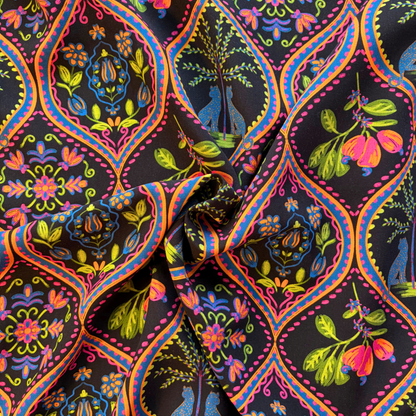 Black tropical bohemian digital print viscose fabric flat lay showing 110gsm fluid drape and 142cm width — leopard and palm motifs in pink purple blue and orange perfect for handmade wrap dresses and wide-leg trousers