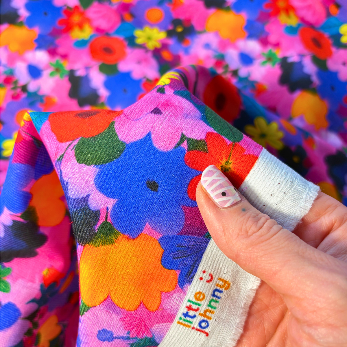 Bright floral needlecord fabric with tightly packed wildflower heads, 100% cotton corduroy 112cm wide 125gsm for slow fashion dressmaking and autumn winter sewing