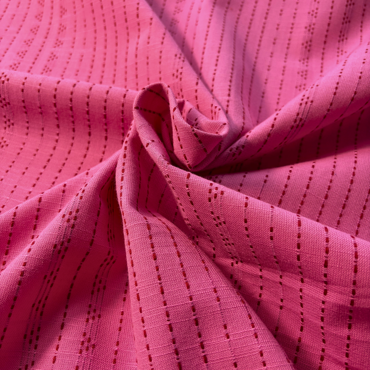 Bright pink and lilac yarn dyed dobby stripe cotton fabric vertical dot and dash woven pattern 145cm wide — 135gsm textured woven dressmaking fabric for handmade blouses dresses and children's clothing