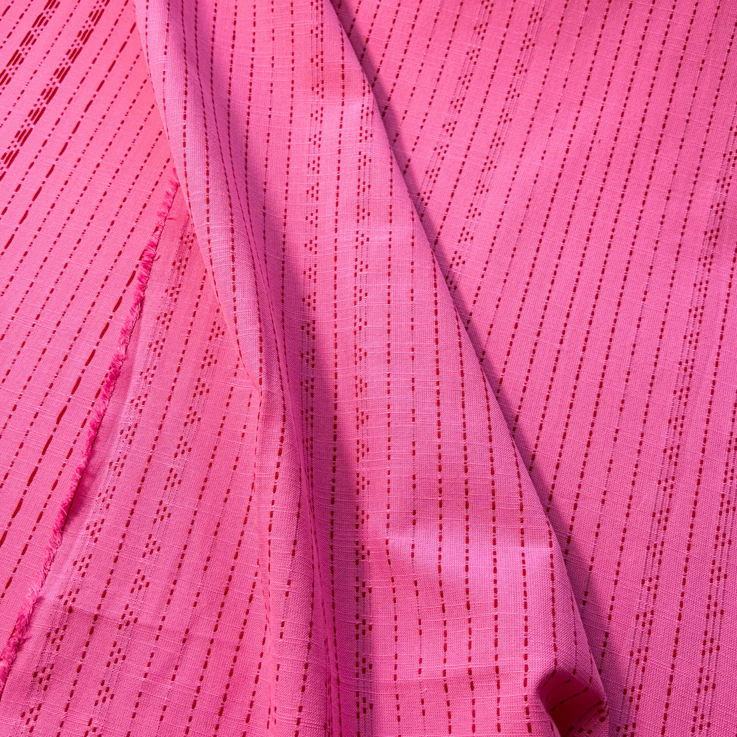 Bright pink and lilac yarn dyed dobby stripe woven cotton fabric vertical dot and dash pattern — 135gsm 100% cotton textured woven for slow fashion dressmaking children's clothing and autumnal makes