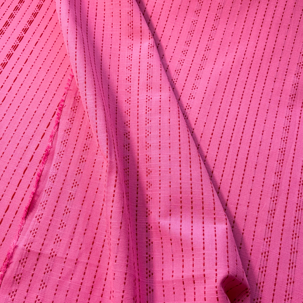 Bright pink and lilac yarn dyed dobby stripe woven cotton fabric vertical dot and dash pattern — 135gsm 100% cotton textured woven for slow fashion dressmaking children's clothing and autumnal makes