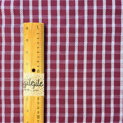 Burgundy lilac dobby check woven cotton fabric folded to show raised 1.8cm grid texture and soft construction — 145cm wide lightweight dressmaking fabric for handmade blouses dresses and skirts