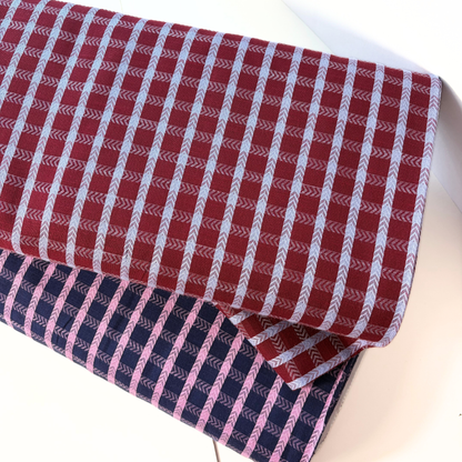 Burgundy lilac dobby check cotton fabric flat lay showing 135gsm natural drape and generous 145cm width — raised woven grid check perfect for handmade dresses blouses and children's pinafores