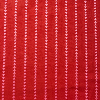 Burnt red pink dobby triangle stripe cotton fabric flat lay showing 135gsm natural drape and generous 145cm width — yarn dyed vertical mini triangle woven stripe perfect for handmade blouses dresses and wide-leg trousers