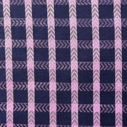 Close-up of navy and pop pink dobby check woven cotton fabric showing raised 1.8cm grid texture and soft woven construction — 135gsm slow fashion dressmaking fabric UK